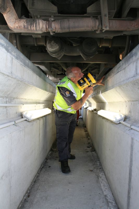  A Police Vehicle Safety Officer (VSO) Ã½ a qualified mechanic Ã½ conducts a safety check from the inspection pit at Glasnevin compliance station
